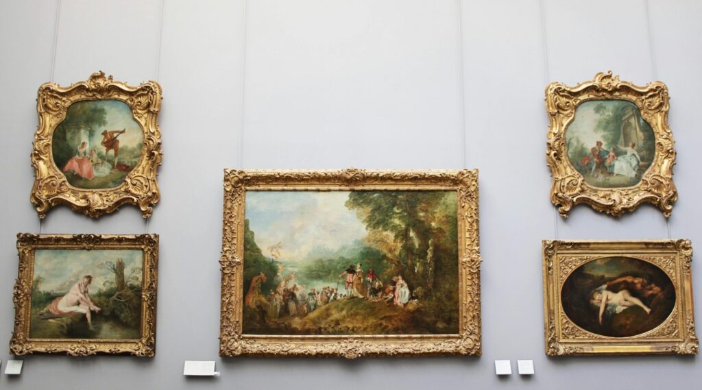 A collection of baroque paintings displayed in a Paris museum, showcasing intricate gold frames and classical art.